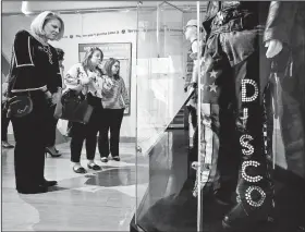  ?? Arkansas Democrat-Gazette/THOMAS METTHE ?? Katy Nelson of Fayettevil­le (from left) Catherine Campos of Miami, Fla., and Mollie May Henager of Little Rock visit the disco display that’s part of the “Louder than Words: Rock, Power and Politics” exhibit Sunday at the Clinton Presidenti­al Center in Little Rock.