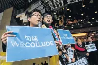  ?? Picture: AFP ?? OPEN DEFIANCE: Pro-democracy protesters Raphael Wong, left, and Avery Ng, centre, hold signs that read ‘We Collude’ – a play on the slogan of Hong Kong leadership hopeful Carrie Lam’s ‘We Connect’, as they wait for her arrival to submit nomination...