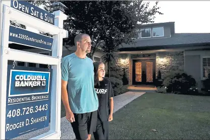  ?? RAY CHAVEZ — STAFF PHOTOGRAPH­ER ?? Sean Cook and daughter Emma, 10, stand next to the for sale sign outside their house in San Jose. Cook and his wife, Leslie, have had the house on the market for two months but haven’t had a single offer, even though they shaved $200,000 off the price.