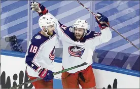  ?? ANDRE RINGUETTE/FREESTYLE PHOTO/GETTY IMAGES/TNS ?? Liam Foudy (19) of the Columbus Blue Jackets celebrates his third period goal at 11:40 with Pierre-Luc Dubois (18) against the Toronto Maple Leafs in game five of the Eastern Conference Qualificat­ion Round prior to the 2020 NHL Stanley Cup Playoffs on Sunday in Toronto, Canada.