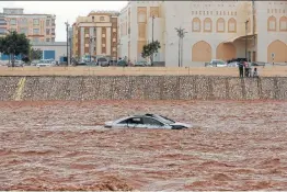  ?? Mohammed Mahjoub / Getty Images ?? A car is stuck in a flooded street in Salalah, Oman. Cyclone Mekunu was downgraded to a deep depression Saturday, a day after lashing the southern coast.