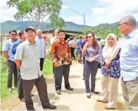  ??  ?? EWON bersama rombongan melawat jalan raya Kg Tambulaung–Podos.