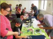  ?? EVAN BRANDT — DIGITAL FIRST MEDIA ?? It became difficult to find a space to work, and enough paint to make your shirt, during Friday’s Galaxy Painting Party at the Pottstown Regional Public Library.