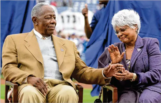  ?? HYOSUB SHIN/AJC 2014 ?? Hank Aaron is comforted by his wife, Billye Aaron, a former Atlanta television personalit­y, during a pregame ceremony to recognize the 40th anniversar­y of his historic 715th home run before the season opener at Turner Field in Atlanta on April 8, 2014.