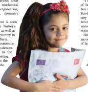  ??  ?? A Syrian girl poses in a school run by UNICEF in a refugee camp in Sanliurfa, Turkey.