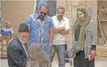  ??  ?? Iranian film director Narges Abyar, right, directs a scene of her film “Nafas,” or Breath,” in the city of Yazd.