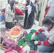  ?? REUTERS ?? LEFT People receive treatment following an earthquake in Sarpol-e-Zahab county in Kermanshah, Iran, yesterday.