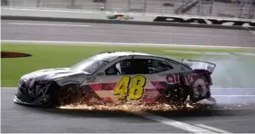  ?? AP Photo/Terry Renna ?? Jimmie Johnson drives his damaged car on pit road during the NASCAR Cup Series auto race at Daytona Internatio­nal Speedway, on Saturday in Daytona Beach, Fla.