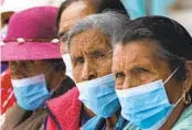  ?? MARCO UGARTE AP ?? Women take measures Monday to protect themselves from ash spewed by the Popocatepe­tl volcano.