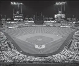  ?? Los Angeles Times/tns ?? The Los Angeles Dodgers and the Milwaukee Brewers in game two of the MLB Wild Card playoffs at an empty Dodger Stadium on Thursday, Oct. 1, 2020 in Los Angeles.