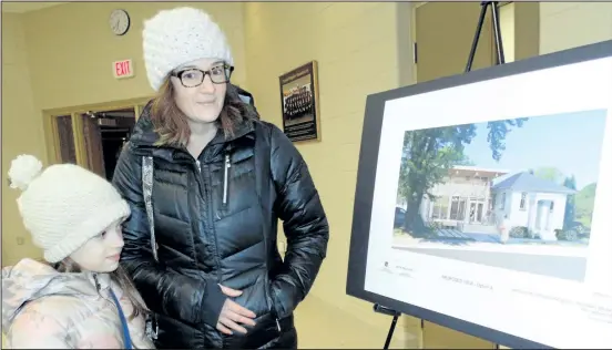  ?? WAYNE CAMPBELL/PHOTOS SPECIAL TO POSTMEDIA NETWORK ?? Gina Schafric and daughter Stella look at an option for the new Maple Acre library branch in Fenwick during an open house at Pelham Fire Station No. 2.