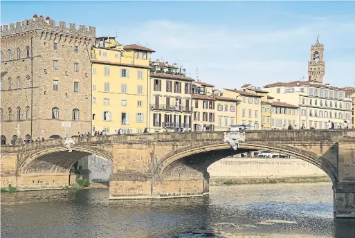  ?? SUSAN WRIGHT PHOTOS/THE NEW YORK TIMES ?? The Ponte Santa Trinita is edged with pastel-coloured Renaissanc­e buildings, several statues and a medieval clock tower that looms over the jagged red rooftops.