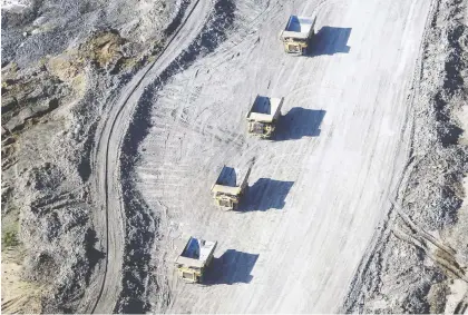  ?? BEN NELMS/BLOOMBERG FILES ?? Global oil majors are under pressure to reduce their carbon footprints, providing a push to sell their holdings in Canada's oilsands, which have a higher CO2 intensity than convention­al oil. Above, bitumen mining at Suncor Energy Inc. in Fort Mcmurray.