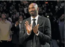  ?? Kevork Djansezian / Getty Images ?? Above: Kobe Bryant is pleased at halftime as both his No. 8 and No. 24 Lakers jerseys are retired at Staples Center.