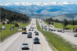  ?? THE ASSOCIATED PRESS ?? Motorists guide their vehicles down Interstate 70 near Evergreen, Colo. Auto insurance companies are using technology to change how they set prices, give discounts, answer common questions and handle claims.