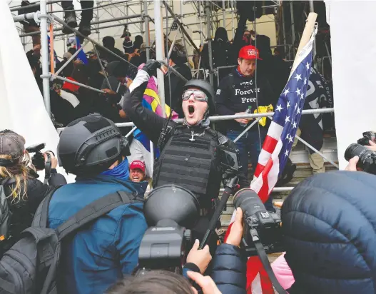  ?? JOSEPH PREZIOSO / AFP ?? A man calls on people to raid the building as Trump supporters clash with police and security forces at the U.S. Capitol Building in Washington D.C. on Jan. 6.