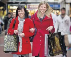  ?? Photos: Gerry Mooney ?? FESTIVE SPIRIT: Diana Bunici, left, and Mily McMeel and Laura McKenna, above, shopping on Grafton Street in Dublin yesterday, on the capital’s busiest shopping day of the year.