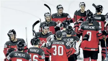  ?? MARTIN MEISSNER/THE ASSOCIATED PRESS ?? Team Canada celebrates after defeating Germany in the quarterfin­als at the world hockey championsh­ip Friday in Cologne, Germany.