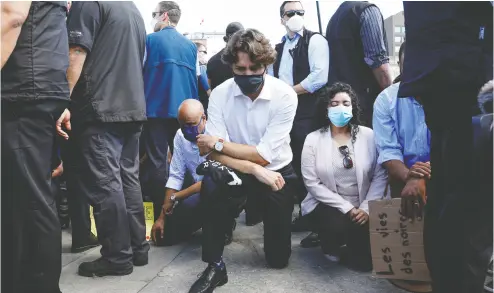  ?? Blair Gable / REUTERS ?? Prime Minister Justin Trudeau wears a mask Friday in Ottawa as he takes a knee during a Black Lives Matter protest against the Minneapoli­s police custody death of George Floyd.