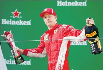  ?? LARS BARON / GETTY IMAGES ?? Kimi Raikkonen of Finland celebrates on the podium during the Formula One Grand Prix in Shanghai on April 15. Raikkonen is fighting against a Montreal woman’s claim that he grabbed her breast in 2016.