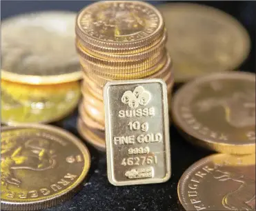  ?? PHOTO: REUTERS ?? Gold bullion is displayed at Hatton Garden Metals precious metal dealers in London. Gold is compatible with Islam.