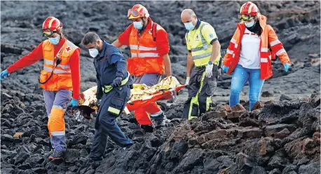  ??  ?? RESCUE workers carry the body of a dead migrant after a boat with 35 migrants from the Maghreb region capsized in the beach of Orzola, in the Canary Island of Lanzarote, Spain, yeserday. | Reuters