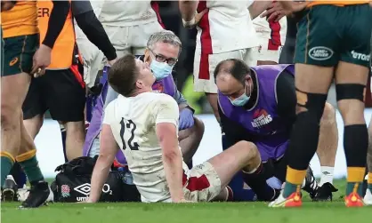  ?? ?? Owen Farrell is treated on the pitch for an ankle injury against Australia at Twickenham. Photograph: Matt Impey/Shuttersto­ck