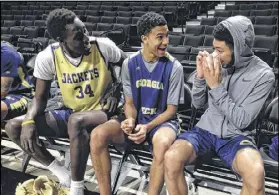  ?? KEN SUGIURA / KSUGIURA@AJC.COM ?? Tech’s Abdoulaye Gueye (from left), Justin Moore and Josh Heath share a laugh after practice Saturday in Winston-Salem, N.C. Health issues kept Gueye and Moore from playing.