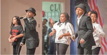  ??  ?? Dexter Elementary School students perform a
New Edition ensemble during the “A Musical Journey Through Time” presentati­on at the Cordova school on Friday.