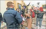  ?? BALCE CENETA/ASSOCIATED PRES FILE PHOTO] ?? In this Jan. 6 photo, supporters of President Donald Trump are confronted by U.S. Capitol Police officers outside the Senate Chamber inside the Capitol in Washington. [MANUEL