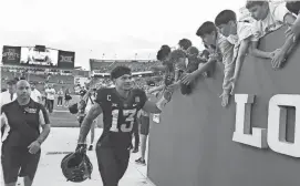  ?? IRMALENDU MAJUMDAR/AMES TRIBUNE N ?? Iowa State receiver Jaylin Noel high-fives fans after helping Iowa State beat Oklahoma State on Saturday at Jack Trice Stadium.