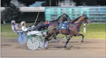  ?? JASON SIMMONDS/JOURNAL PIONEER ?? The Kenny Arsenault-driven Czar Seelster edges out Euchred, driven by Adam Merner, to win the 50th running of the Governor’s Plate in 1:53.2 at Red Shores at Summerside Raceway on Saturday night. The race, presented by Township Chevrolet, featured a $25,000 purse.