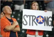 ?? ERIC CHRISTIAN SMITH — THE ASSOCIATED PRESS ?? A fan holds a sign during the national anthem before the first game of Saturday’s doublehead­er between the New York Mets and the Houston Astros at Minute Maid Park.