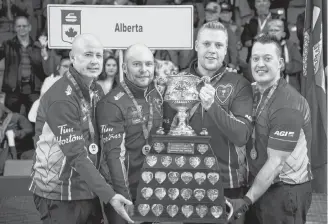  ?? CP PHOTO ?? Team Alberta skip Kevin Koe (left to right), third B.J. Neufeld, second Colton Flasch and lead Ben Hebert hold the Brier tankard after beating Team Wild Card at the Brier in Brandon, Man. Sunday