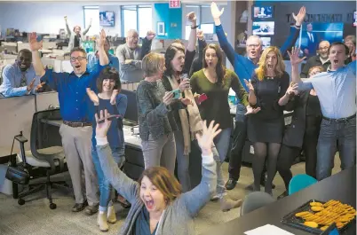  ??  ?? Amber Hunt (front), a Cincinnati Enquirer reporter, and other staff journalist­s react to news of winning a Pulitzer Prize for local reporting for their “Seven Days of Heroin” project. — Reuters