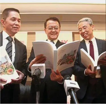  ??  ?? Good report: (from left) President of Sunway Group Datuk Chew Chee Kin, Cheah, chief financial officer Chong Chang Choong checking out the company’s annual report at the AGM.