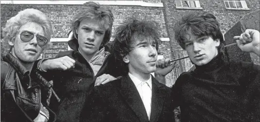  ?? Paul Slattery ?? CIRCA 1979: U2’s Adam Clayton, from left, Larry Mullen Jr., the Edge and Bono. The young Irish band begins to look around and ask what’s going on in the world.