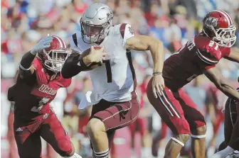  ?? AP PHOTO ?? OUT OF REACH: Mississipp­i State quarterbac­k Nick Fitzgerald (7) runs on a keeper between UMass safeties Lee Moses and Khary Bailey-Smith yesterday at Gillette Stadium.