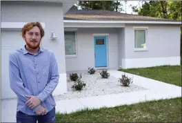  ?? JOHN RAOUX — THE ASSOCIATED PRESS ?? First-time buyer Kevin Muglach stands in front of his new home, Tuesday in Orange City, Fla. Homebuyers are facing the most competitiv­e U.S. housing market in decades this spring, as surging prices and a record-low number of homes for sale narrow the already difficult path to home ownership for many Americans.