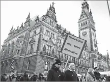  ?? MORRIS MAC MATZEN / AFP ?? A protester holds a placard reading “Democracy has no alternativ­e” during a demonstrat­ion against far-right politics on Sunday in front of the city hall in Hamburg, northern Germany.