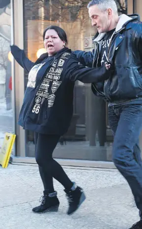  ?? JOHN WOODS /THE CANADIAN PRESS ?? Valentina Duck, Tina Fontaine’s mother, yells at reporters after a jury delivered a not-guilty verdict Thursday in the second-degree murder trial of Raymond Cormier.