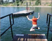  ?? GARY NYLANDER/ ?? Nykoli Freyling, 7, of Lethbridge jumps off a diving platform at the CNR Wharf Park, also called the Old Ferry Docks, on Thursday morning. Nykoli and his sister, Shayla, 9, and their mother were enjoying a hot, summer day while visiting their...