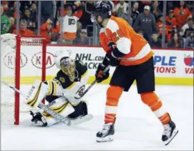  ?? TOM MIHALEK — THE ASSOCIATED PRESS ?? The Flyers’ Claude Giroux, right, scores the game-winning goal in overtime past Boston Bruins goalie Anton Khudobin Sunday in a 4-3 decision.