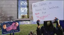  ?? JIM MONE/AP ?? Demonstrat­ors gather during a news conference Monday outside the Hennepin County Government Center in Minneapoli­s, where former police officer Derek Chauvin’s trial began with opening statements from both sides.