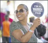  ?? Benjamin Hager Las Vegas Review-Journal ?? Lesha Lucas holds a sign for Sen. Elizabeth Warren, D-Mass., during the fifth annual Community BBQ.