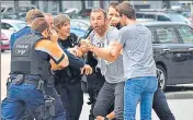  ??  ?? ■ Police calm a man at the scene of the shooting in Liege.