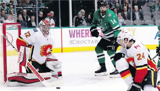  ?? THE ASSOCIATED PRESS ?? Flames goalie Jon Gillies turns a shot away from Stars sniper Jamie Benn Tuesday in Dallas, but Gillies failed to pick up his third straight win with Mike Smith injured.