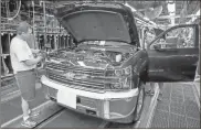  ?? Steve Fecht/general Motors/tns, File ?? General Motors Flint Assembly employees Al Havens (left) and Dan Hippenstee­l work on a Chevrolet Silverado 2500 HD truck during final assembly in 2015 in Flint, Michigan. The company will run the plant on one shift for a week starting July 26, 2021, due to the shortage of semiconduc­tor chip parts.