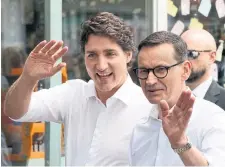  ?? FRANK GUNN THE CANADIAN PRESS ?? Prime Minister Justin Trudeau and his Polish counterpar­t, Mateusz Morawiecki, enjoy a walk in downtown Toronto on Friday.