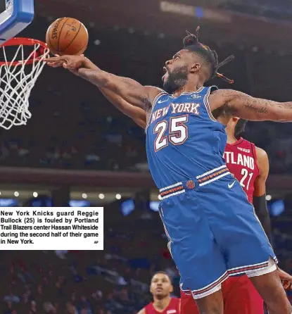  ?? AP ?? New York Knicks guard Reggie Bullock (25) is fouled by Portland Trail Blazers center Hassan Whiteside during the second half of their game in New York.